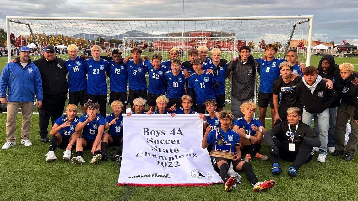 Caldwell poses with the 4A state championship banner and trophy after beating Bishop Kelly in a shootout at Real Life Fields in Post Falls.