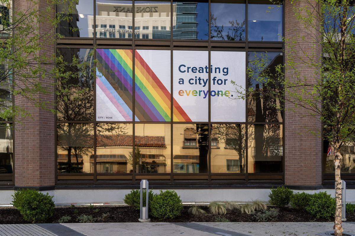 After removing Pride Flags at Boise City Hall, per new laws passed by the Idaho Legislature, the flagpoles are now rainbow striped and a sign is visible in a window on the front of the building, Tuesday, April 7, 2026.
