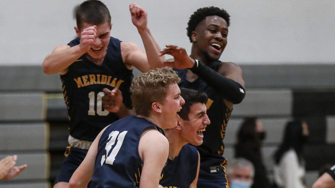 Meridian celebrates winning the 5A SIC District Three title with a 54-45 win over conference rival Rocky Mountain Friday, Feb. 26, 2021 at Capital High School in Boise.