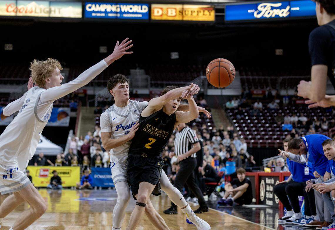 Bishop Kelly junior Owen Graves passes the ball to senior Garrett LaBrie as Preston sophomore Wayd Bailey defends Graves during their 5A boys basketball state tournament semifinals game held at the Ford Idaho Center in Nampa, Friday, March 6, 2026. Bishop Kelly won 63-60.