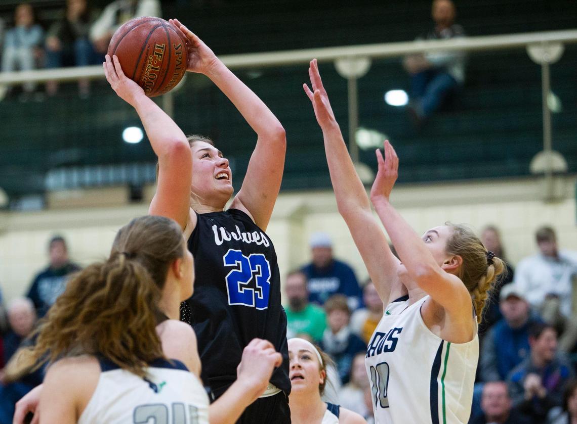 Timberline senior Emma Ellinghouse takes a shot in the paint defended by Mountain View’s McKenzie Cook in the 5A District Three girls basketball championship Friday at Borah.
