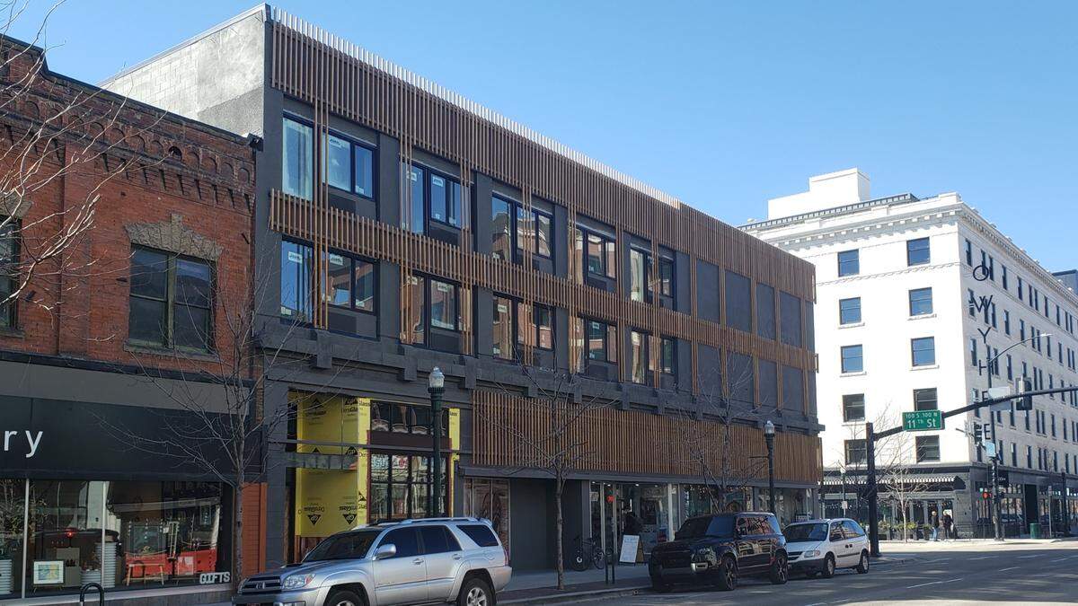 The facade of the old Safari Inn at 11th and Main Streets in downtown Boise has been replaced by wood slats. Windows are larger and air conditioner units are no longer visible from outside. Across 11th Street, The Owyhee building is visible at right.