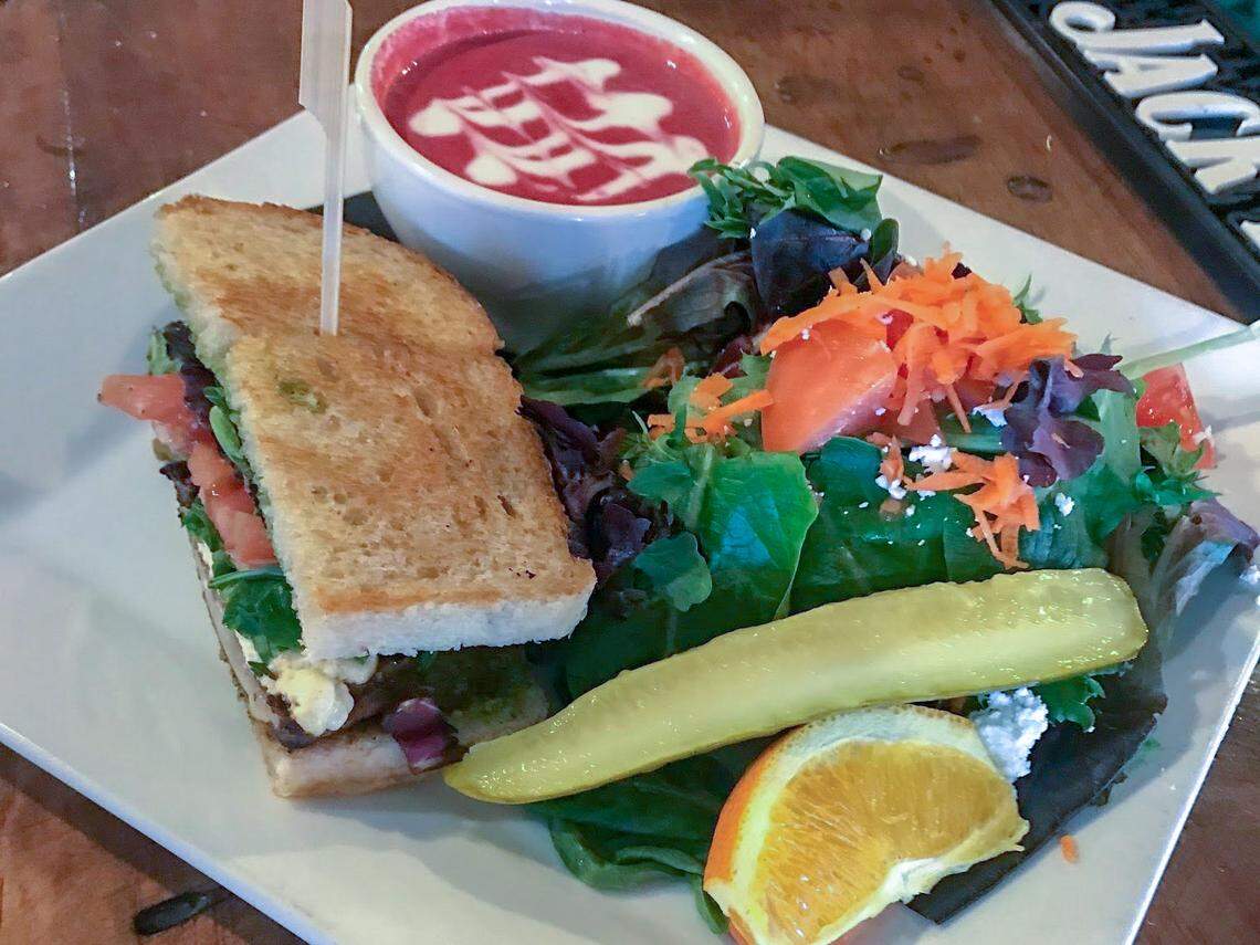 The Barrelhouse serves a new $10 soup, salad and half-sandwich combination from 11 a.m.-3 p.m. Pictured: A grilled portobello sandwich, beet soup with a coconut swirl, and a house salad.