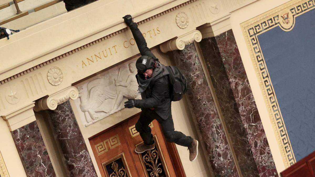 Boise resident Josiah Colt descends from the public gallery to the floor of the Senate chamber at the U.S. Capitol during the Jan. 6 riot. Colt pleaded guilty to an obstruction charge in a plea deal.