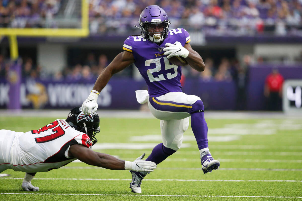Minnesota Vikings running back Alexander Mattison eludes a tackle by Atlanta Falcons defensive tackle Grady Jarrett on Sept. 8. Mattison is a former Boise State standout.