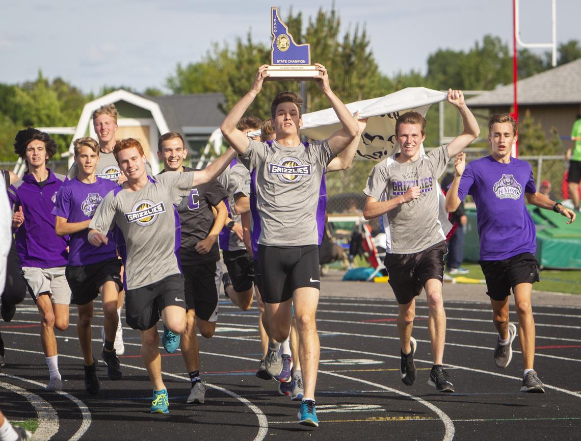 Rocky Mountain’s boys track team takes a victory lap with the first-place 5A team trophy at the Idaho state track and field championships at Eagle High School on May 18.
