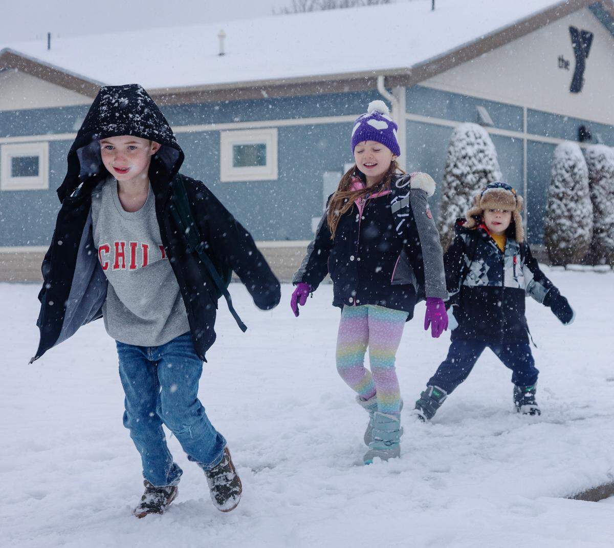 Students Remington Mallard, Summer Packham and May Packham walk to Siena Elementary School in Meridian as it snows on Thursday morning, Jan. 19, 2023.