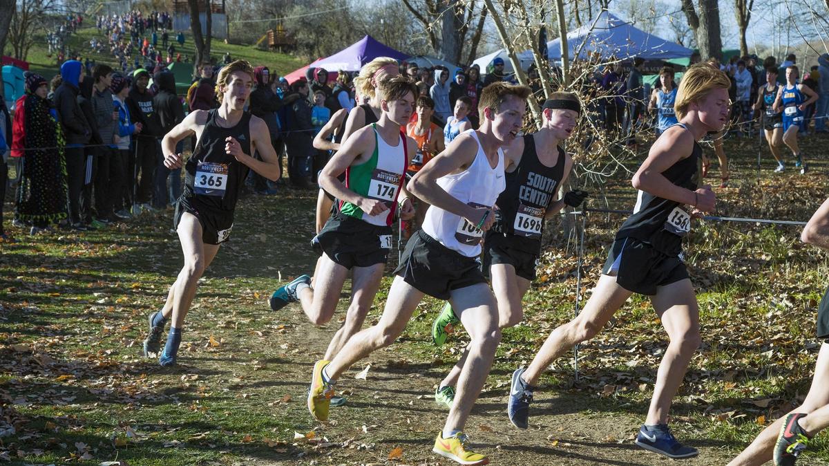  Borah High’s Nathan Green, center, rounds a corner with  Bishop Kelly runner Nick Russell, right, during the Nike Cross Regionals Northwest meet is Saturday, Nov. 10, 2018 at Eagle Island State Park.