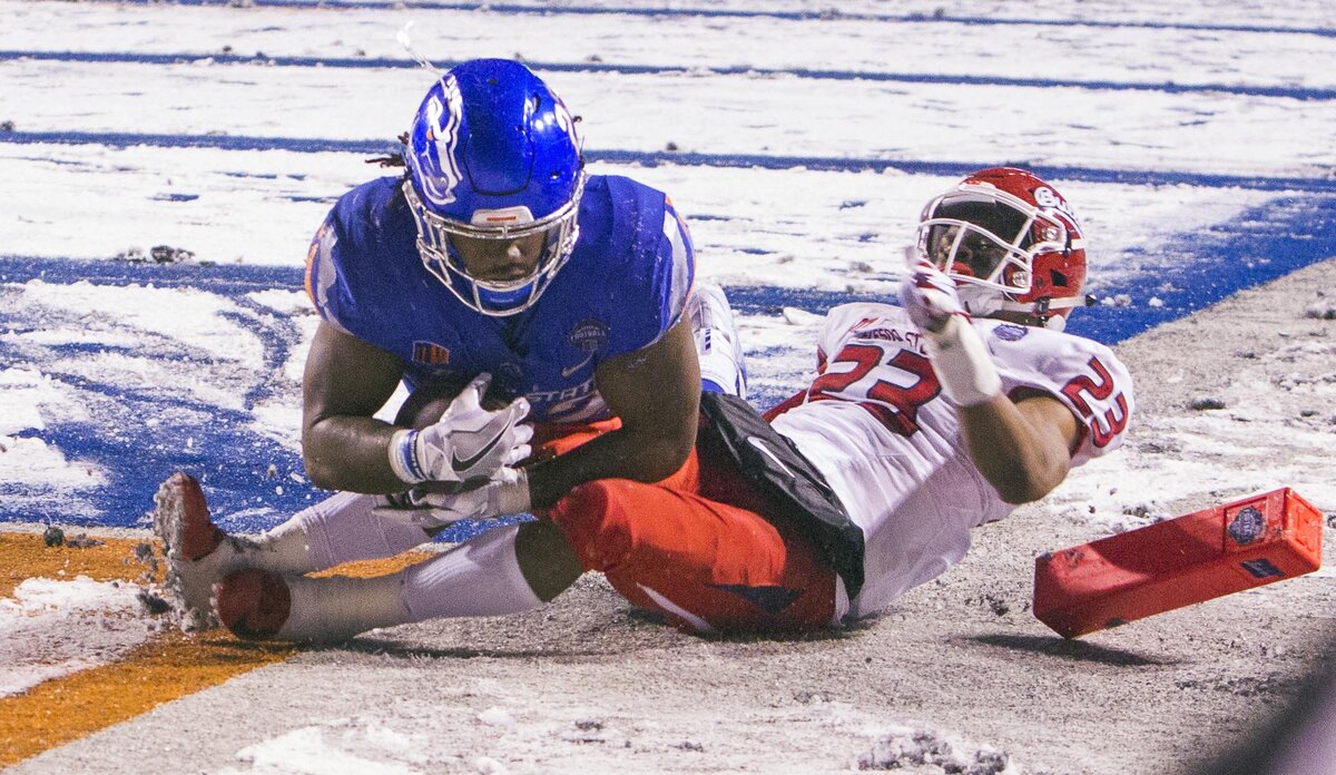 Boise State running back Alexander Mattison scores a touchdown defended by Fresno State defensive back Juju Hughes in the fourth quarter of the Mountain West championship game Saturday at Albertsons Stadium in Boise.