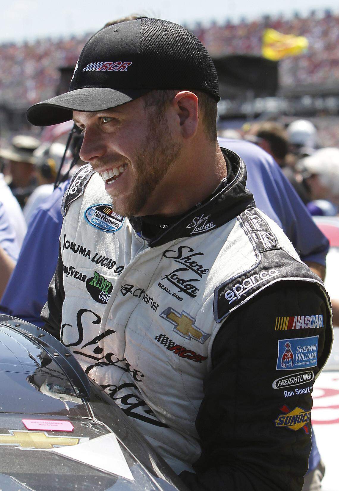 Driver Brian Scott leaves his car after taking the pole during qualifying for a NASCAR Sprint Cup Series auto race in May 2014 at Talladega Superspeedway in Alabama.