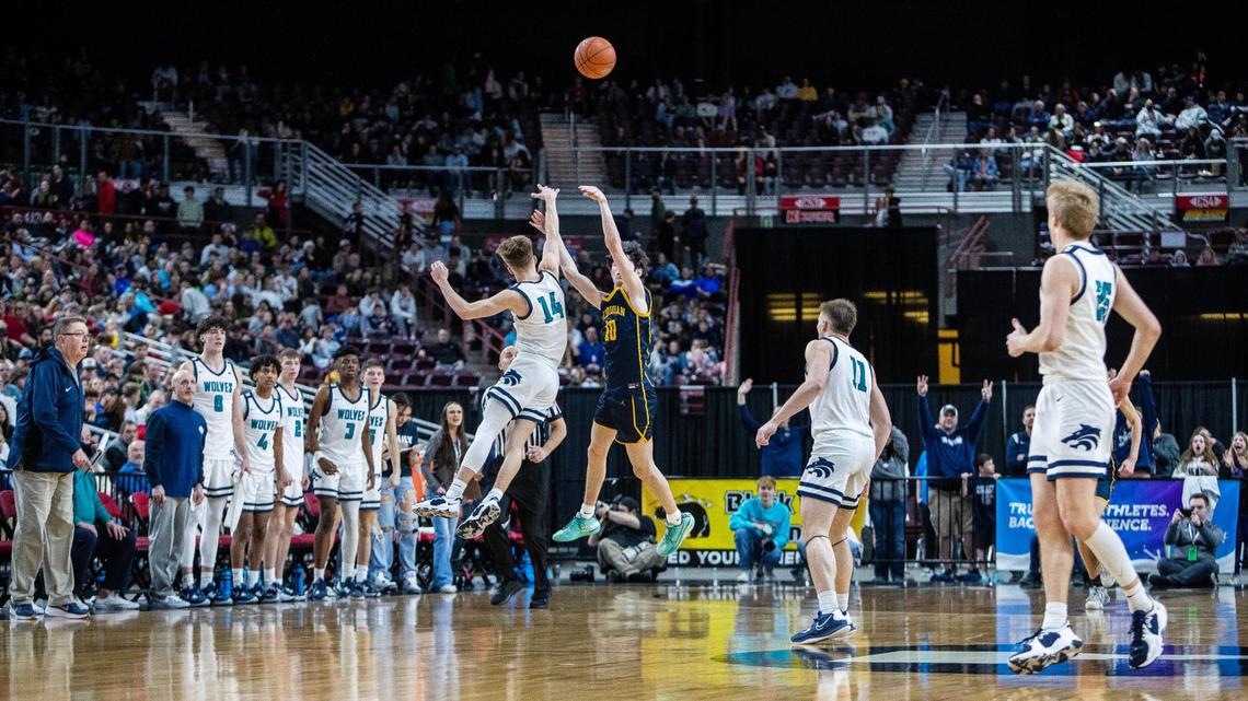 Meridian junior Ryan Baker shoots over a Lake City defender Saturday.