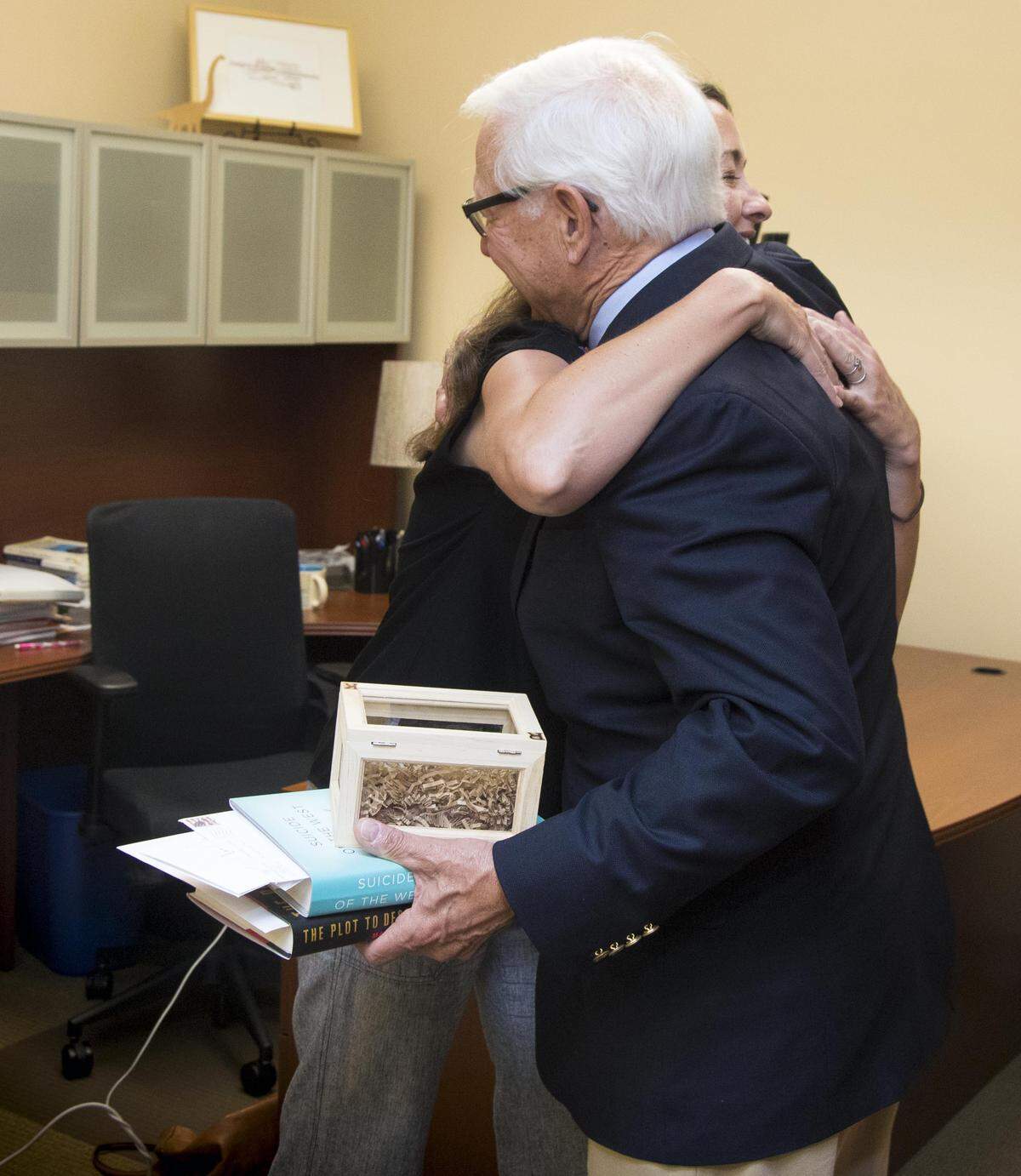 Kelly Myers, who heads Boise State's Beyond the Major program, gives Bob Kustra a farewell hug as he leaves the office.