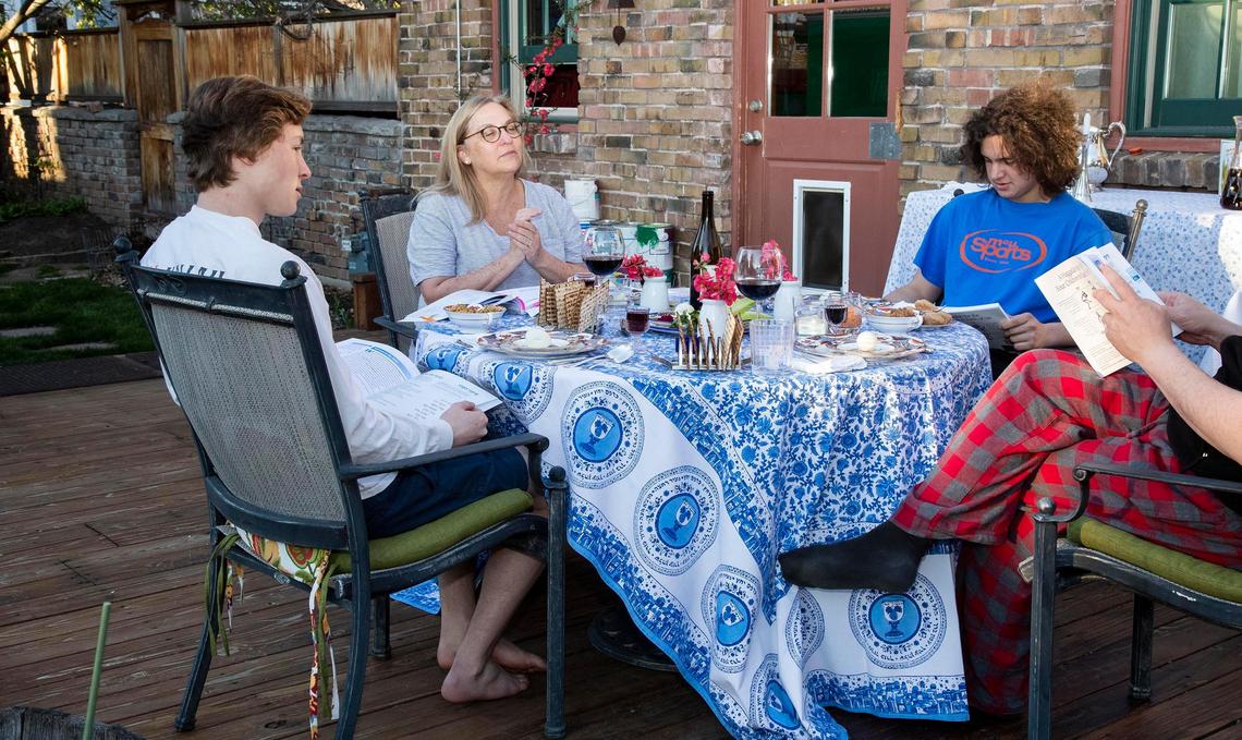 Beth Harbison begins the Passover Seder with her husband and sons, Zane and Trey, on the patio of their Boise home. Adhering to the statewide COVID-19 stay-at-home order, the family practices the ritual feast on their own. Traditionally the Seder Dinner is shared among friends and multiple families.