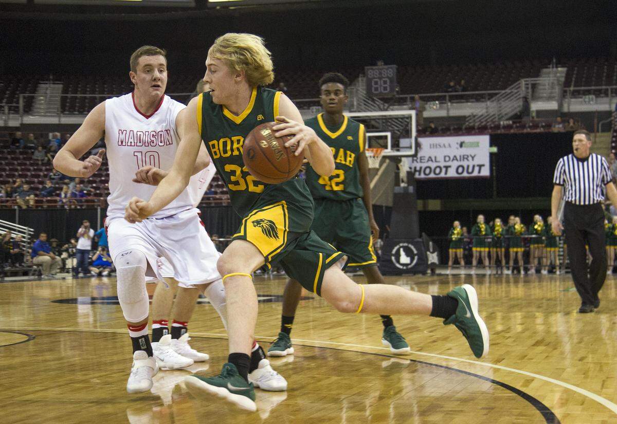 Borah’s Austin Bolt drives past Madison’s Joe Dougherty in the first round of the 5A state tournament last season.