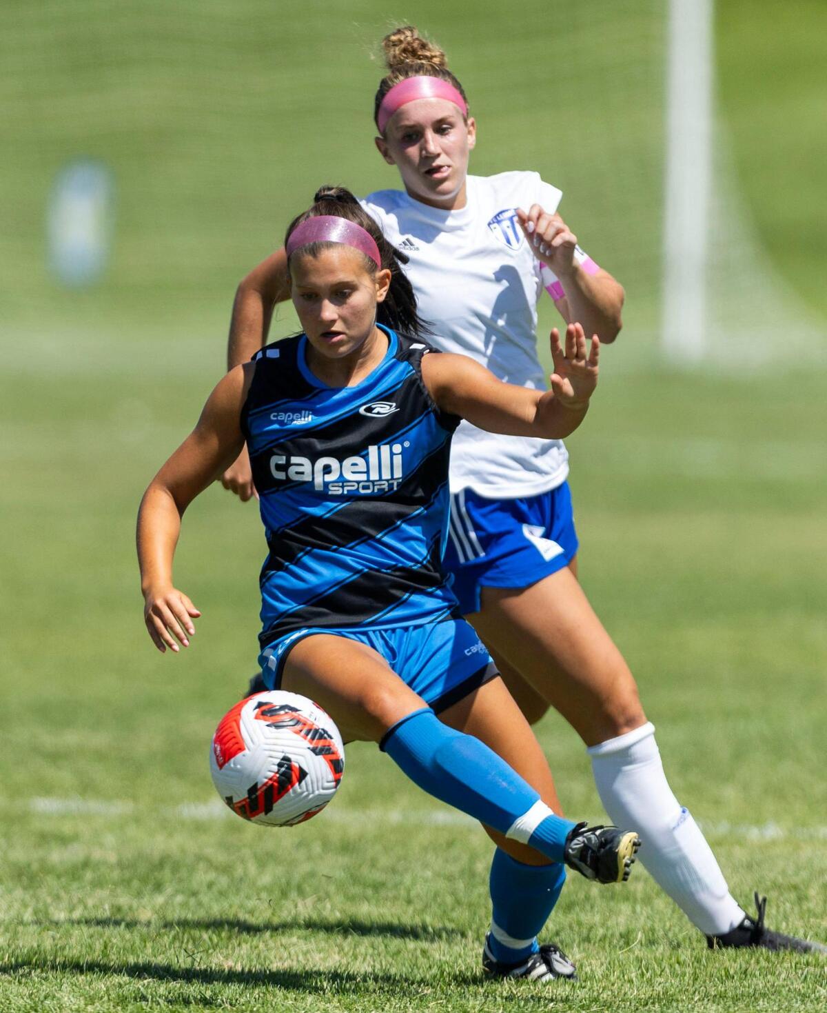 Idaho Rush’s Rosemary Rubio controls the ball at midfield Thursday in front of Utah County SC’s Audrey Jones in the U-19 girls U.S. Youth Soccer Far West Regional championship game Thursday at the Simplot Sports Complex in Boise.