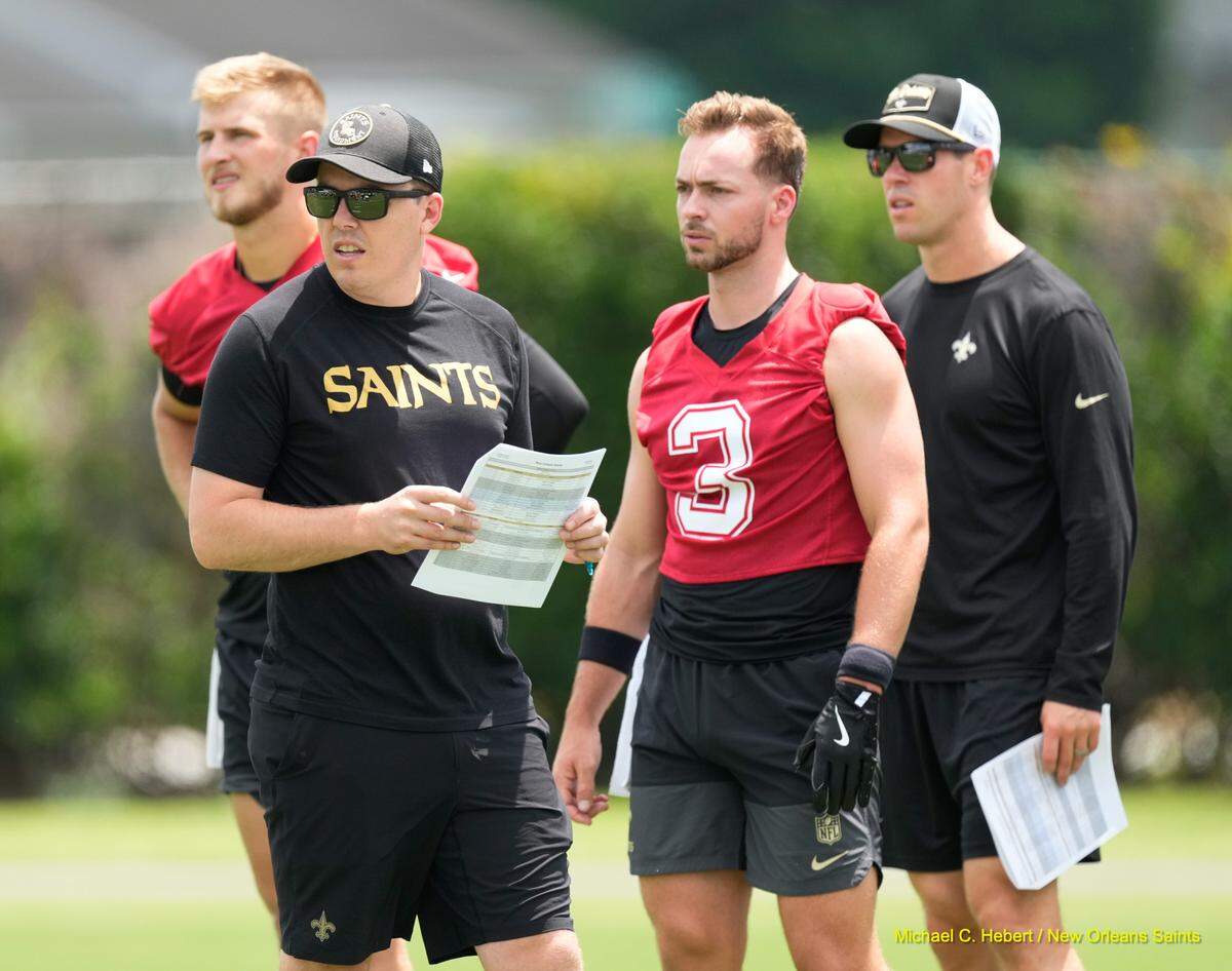 Kellen Moore talks with New Orleans Saints quarterback Jake Haener at the Saints’ minicamp from June 10-12.