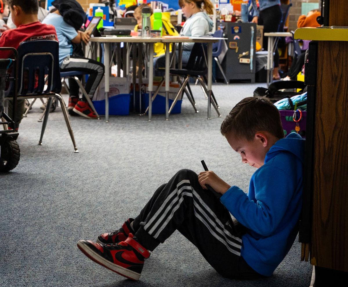 Bodee Wilson, a 2nd-grader at Centennial Elementary in Nampa, reads from an electronic tablet.
