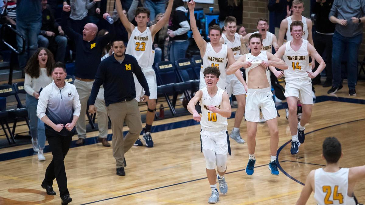 The Meridian High boys basketball team celebrates a 45-43 victory over Borah on Friday at Meridian.