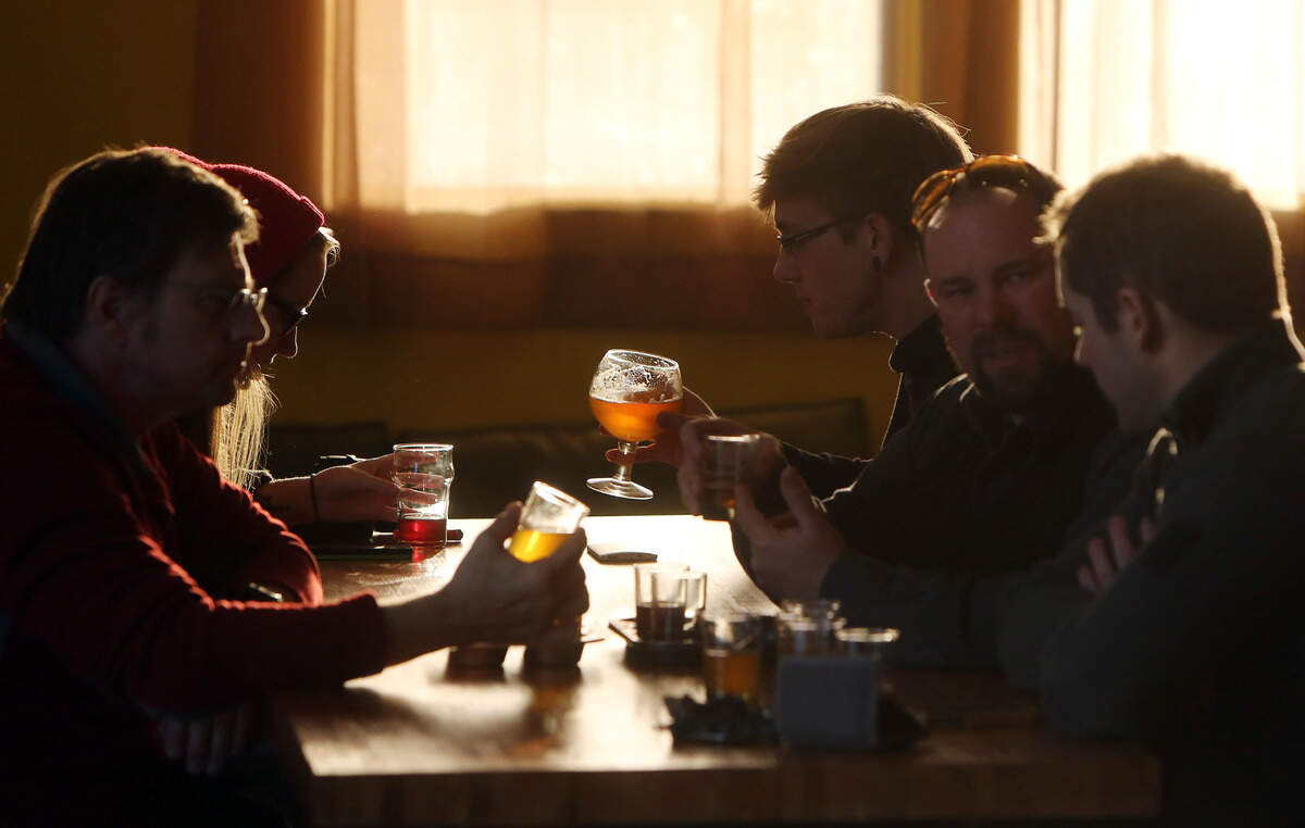 Patrons at Woodland Empire Ale Craft enjoy craft beers shortly after it opened in downtown Boise.