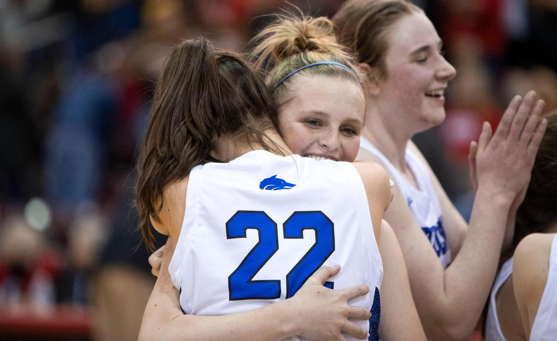 Timberline junior Piper Davis hugs teammate Grace Mertes after winning the 5A girls state basketball championship Saturday.
