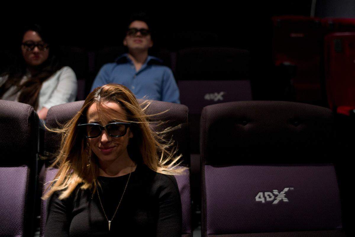 A wind effect is demonstrated on marketing director Yassamine Wahab at the CJ’s 4DX Lab in Hollywood. With domestic movie theater attendance stagnant in recent years, owners like Regal want to provide immersive jolts to goose both moviegoers and box office revenues.