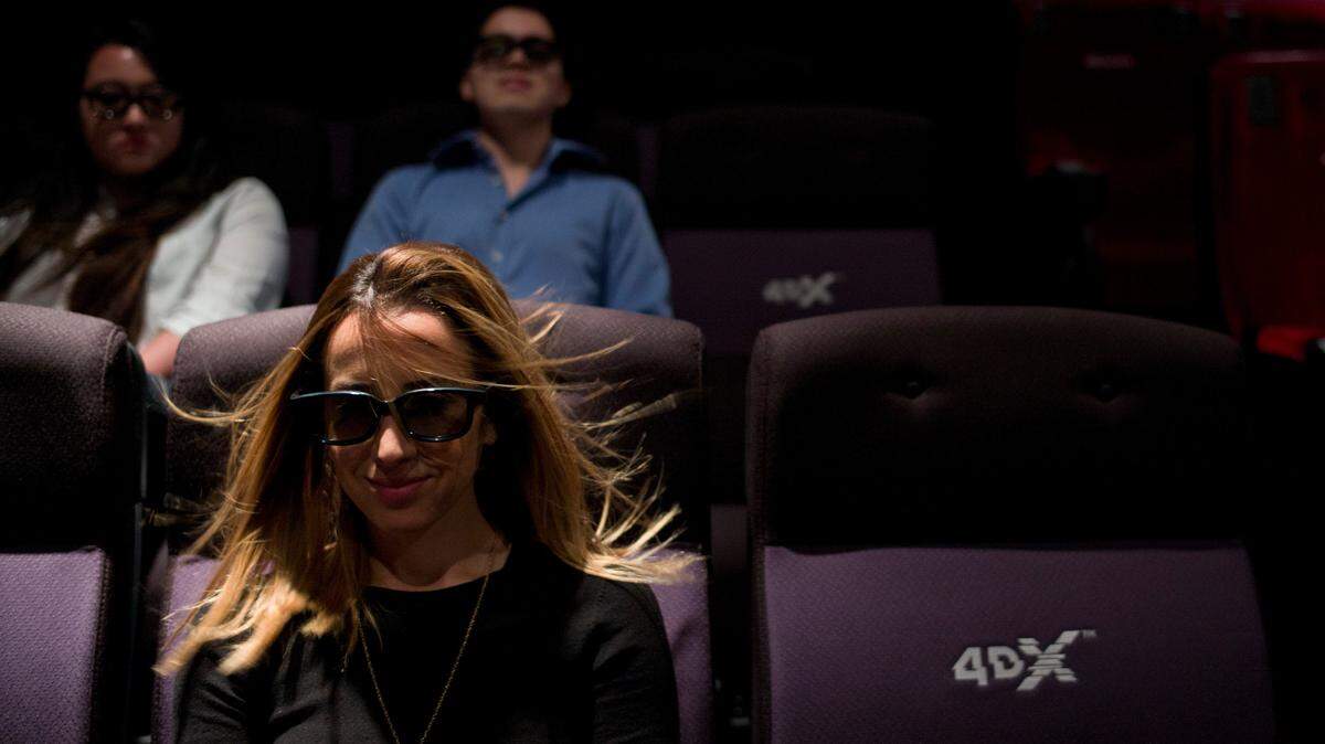 A wind effect is demonstrated on marketing director Yassamine Wahab at the CJ’s 4DX Lab in Hollywood. With domestic movie theater attendance stagnant in recent years, owners like Regal want to provide immersive jolts to goose both moviegoers and box office revenues.