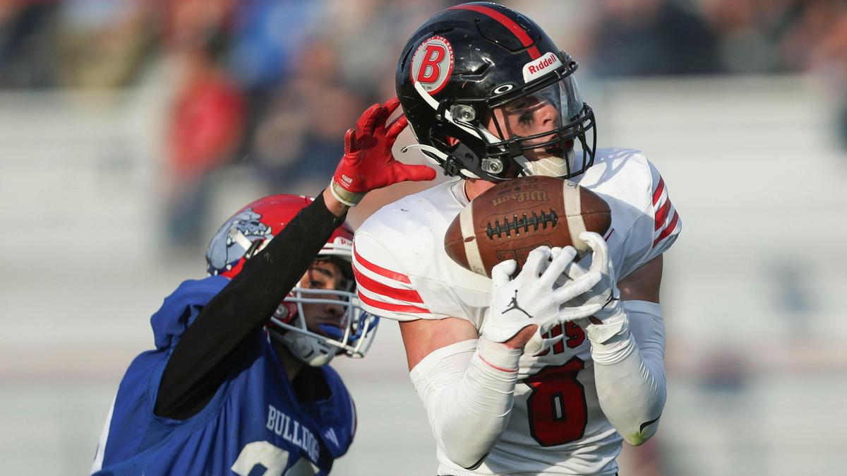 Boise wide receiver Cooper Smith catches a long pass over Nampa defensive back Antonio Sandoval on Friday.