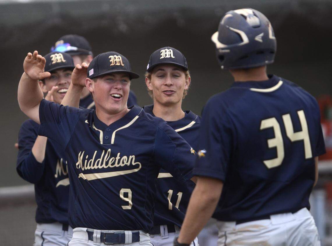 Middleton's Chad Stewart (9) celebrates a run with Darin Post (34) during the 4A state baseball championship against Minico on Saturday at Melaleuca Field in Idaho Falls.