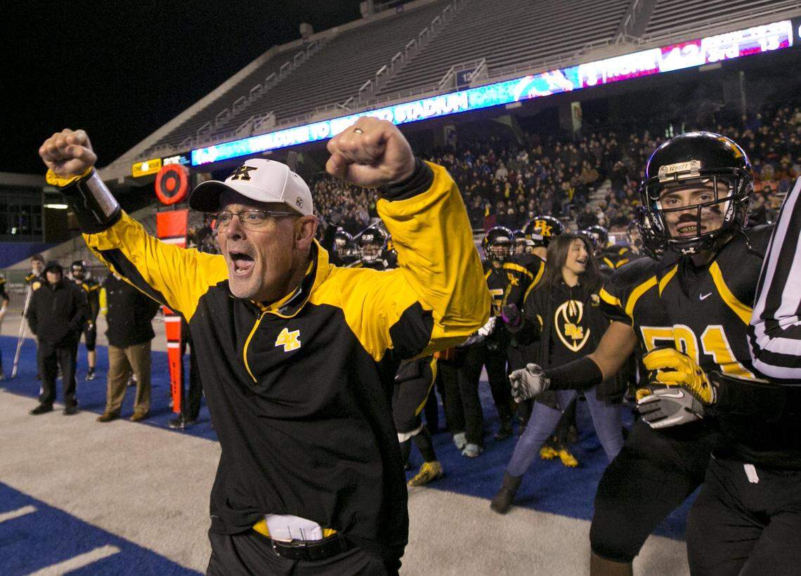 Bishop Kelly coach Tim Brennan celebrates his team’s 2013 state championship win over Skyview at Albertsons Stadium. Brennan announced his retirement as the Knights’ coach Thursday.