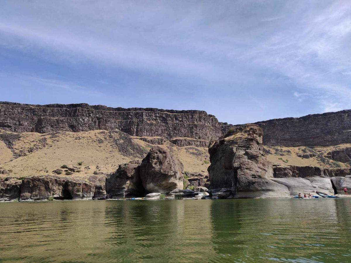 Kayakers and swimmers gather at Pillar Falls on the Snake River on August 3, 2019. Pillar Falls is roughly the halfway point for people paddling upriver to Shoshone Falls.