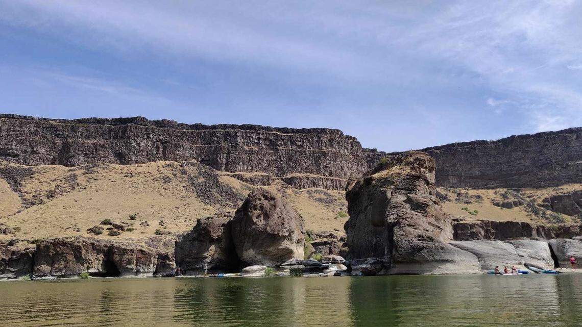 Kayakers and swimmers gather at Pillar Falls on the Snake River on August 3, 2019. Pillar Falls is roughly the halfway point for people paddling upriver to Shoshone Falls.