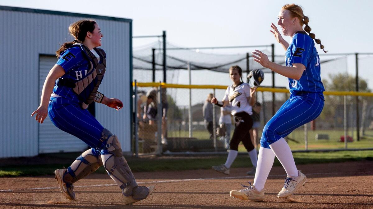 Emmett pitcher Karadyn Fuller meets catcher Raegyn Dupree, left, midway to celebrate their 7-4 win over Bishop Kelly in the 4A District Three softball championship game last May.