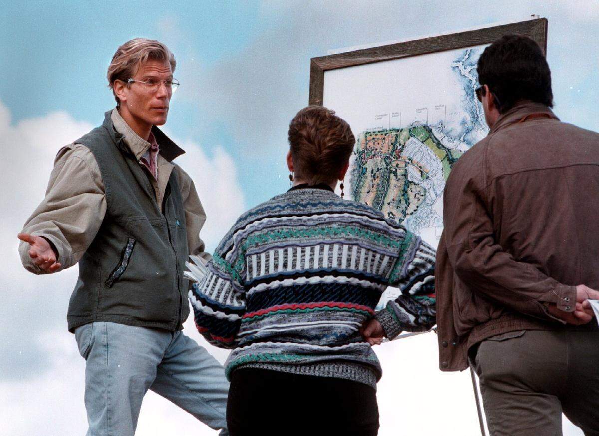 This photo from 1998 shows developer Jim Grossman going over the master plan for Hidden Springs to home shoppers Teresa and Marc Clark. The new Foothills subdivision will include some of the features planners like and firefighters question, such as alleys and narrow streets.