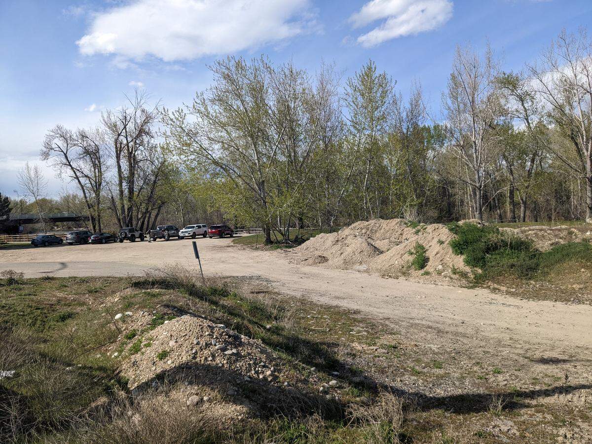 Cars fill up a makeshift parking lot next to the Greenbelt near the site of a potential 125-unit apartment building at 444 W. Parkcenter Blvd. in Southeast Boise.