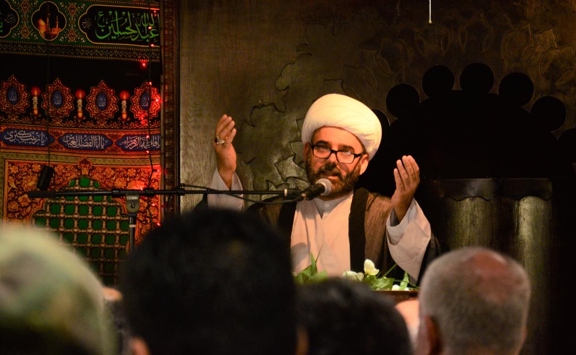 Imam Asaad Alassadi offers a prayer during a service Sunday evening at the Imam Hussain Islamic Center. He called Boise "very welcoming" for refugees and said Saturday night's attack doesn't change that. "We are going to keep building this city because we are part of this city."
