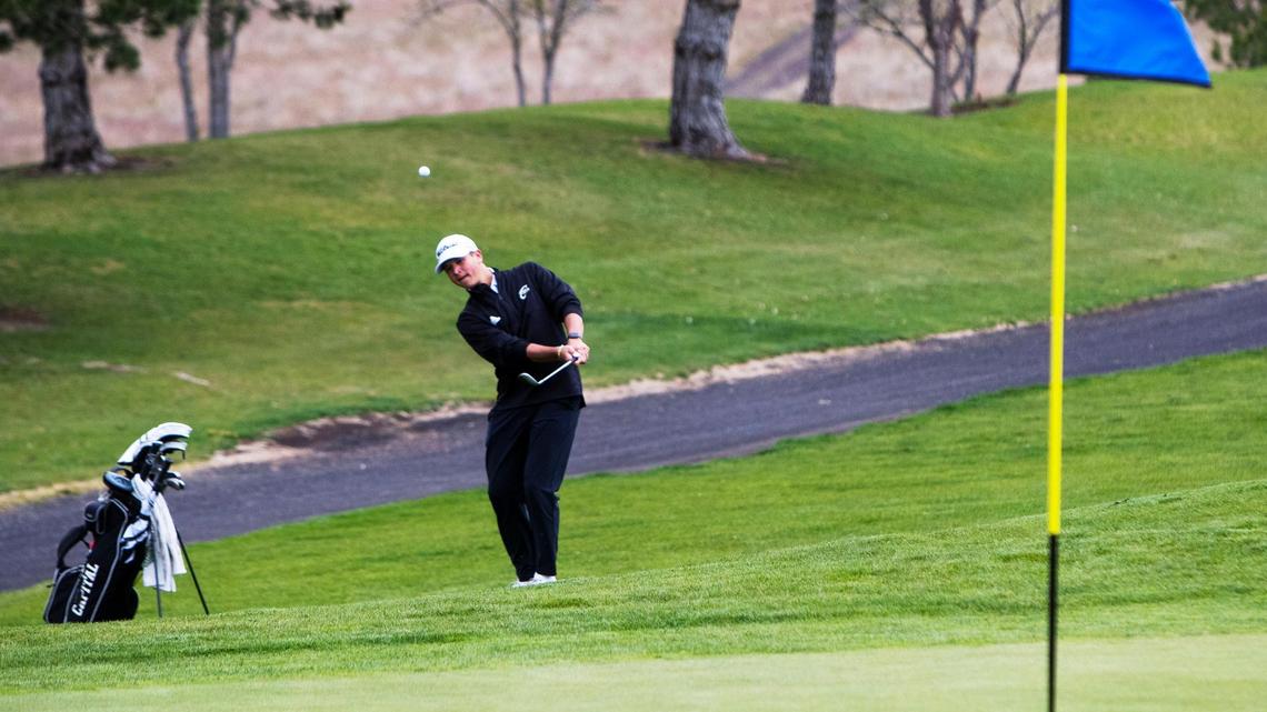 Capital sophomore Trevor Garus chips onto the No. 1 green during the 5A District Three boys golf tournament at Falcon Crest Golf Club in Kuna on Monday.