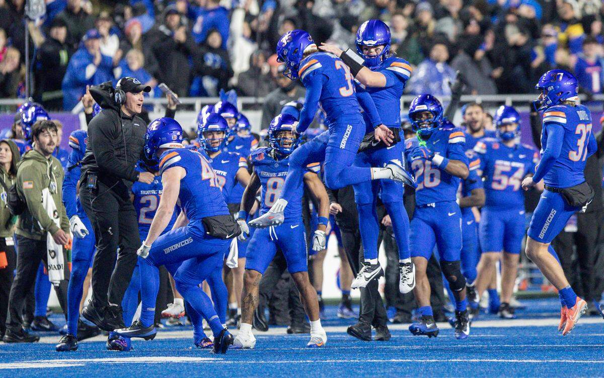 Boise State kicker Colton Boomer jumps into the air with quarterback Maddux Madsen and Boise State head coach Spencer Danielson after hitting a 50-yard field goal in the 2025 Mountain West title game.