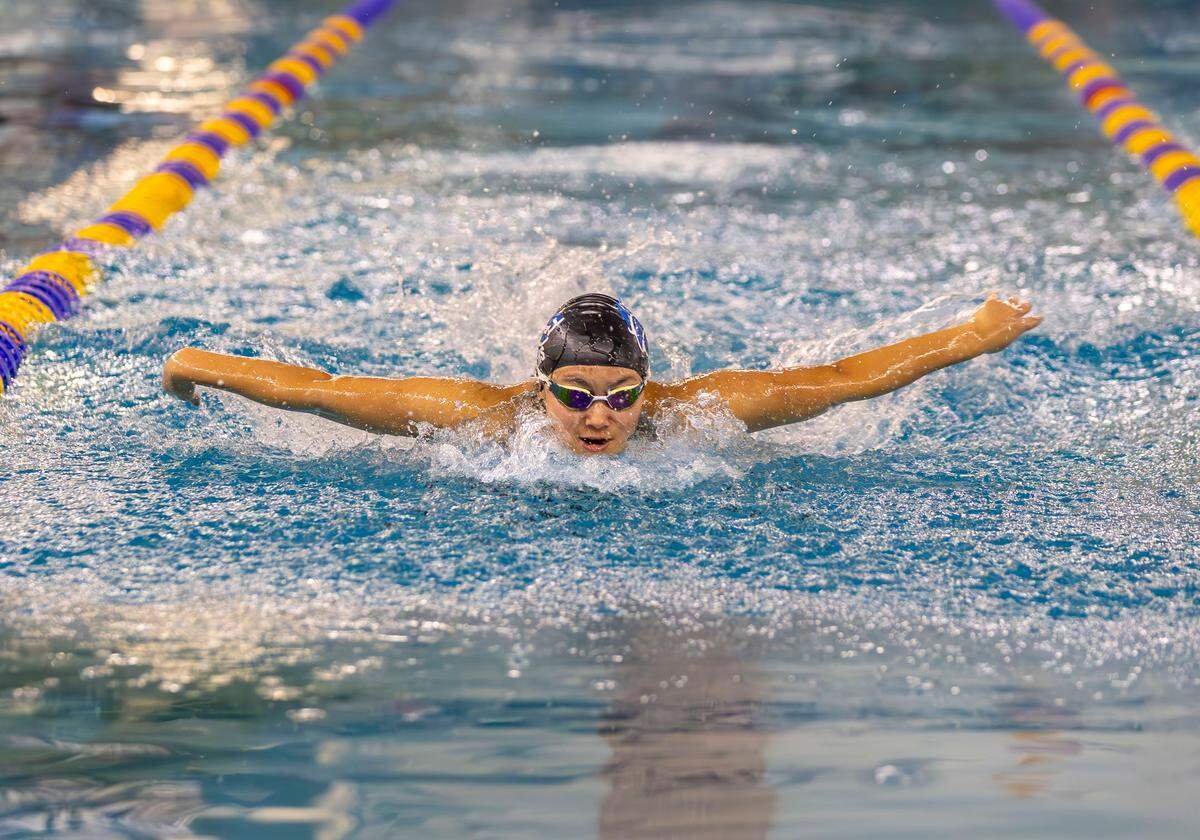 Timberline senior Kathy Nie repeated as the 6A girls state champion in the 100-yard butterfly and set an all-class state record of 56.15 seconds Saturday at the West YMCA.