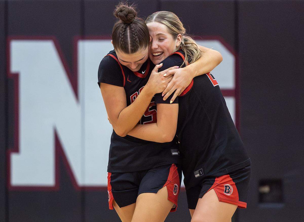 Boise senior Libby Nelson, left, and senior Olivia Chatfield, right, embrace as they win over Middleton in the semifinals of the 6A District Three girls basketball tournament held at Centennial High School, Saturday, Feb. 7, 2026. Boise won 59-51.