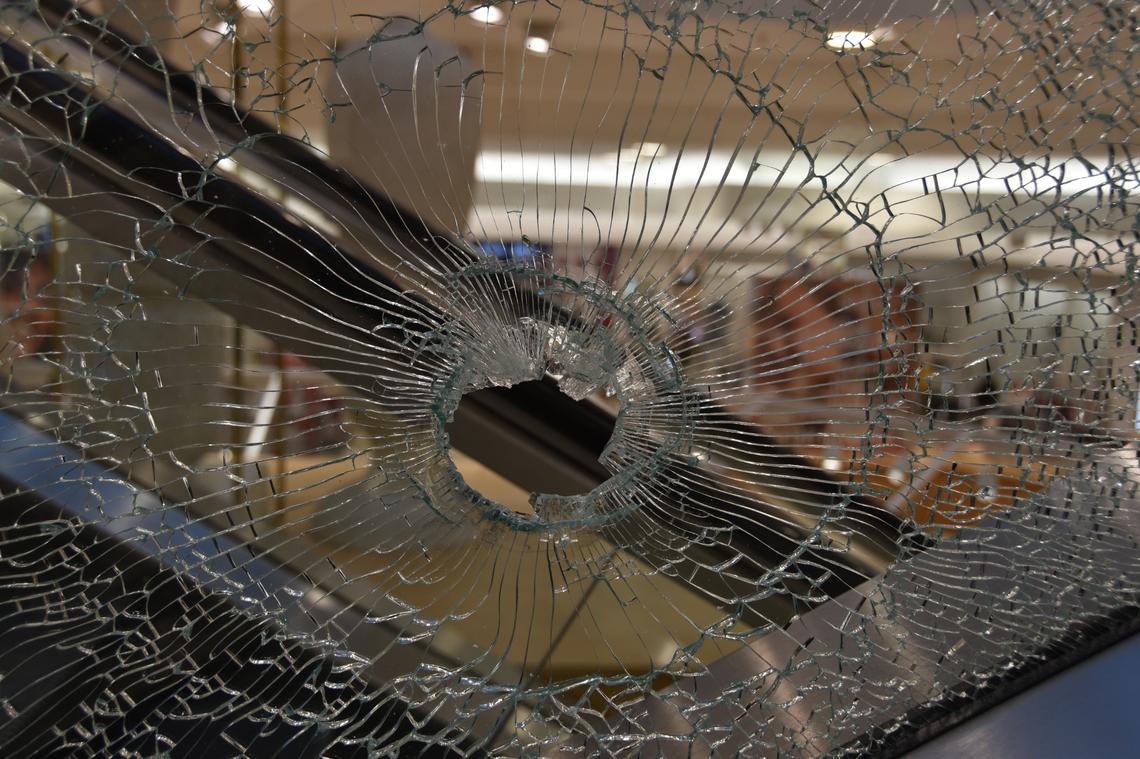 What appears to be a bullet hole in the glass side of an escalator at the Boise Towne Square Mall in October 2021. One of the shooting’s victims was shot on an escalator.