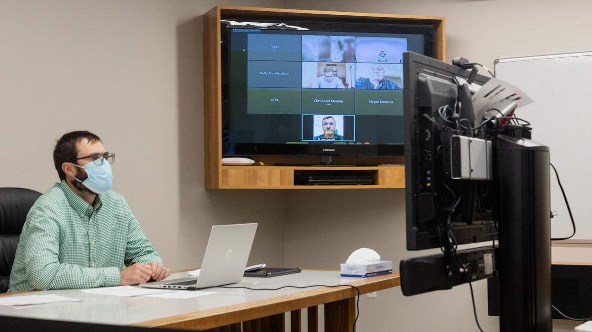 Central District Health Director Russ Duke is recorded live from the CDH meeting room while the board members are displayed on a screen on Tuesday.