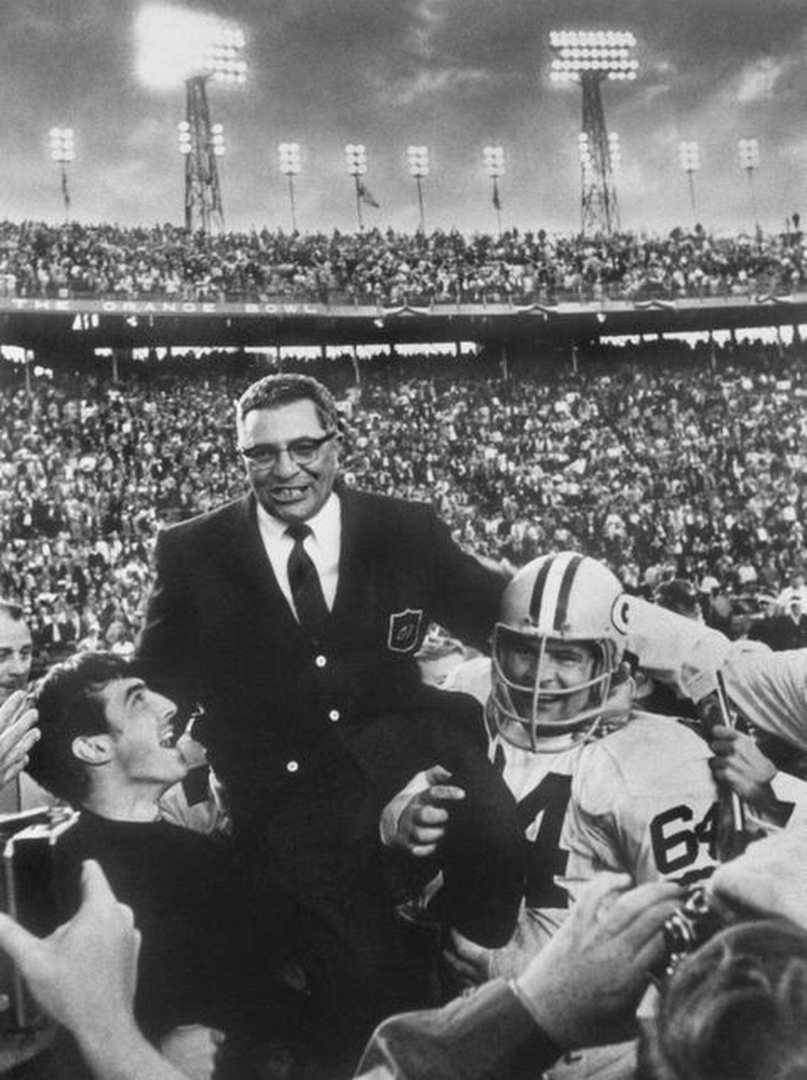 Green Bay Packers head coach Vince Lombardi is carried off the field by team members, including guard Jerry Kramer, right, after the Packers defeated the Oakland Raiders 33-14 in Super Bowl II in 1968.