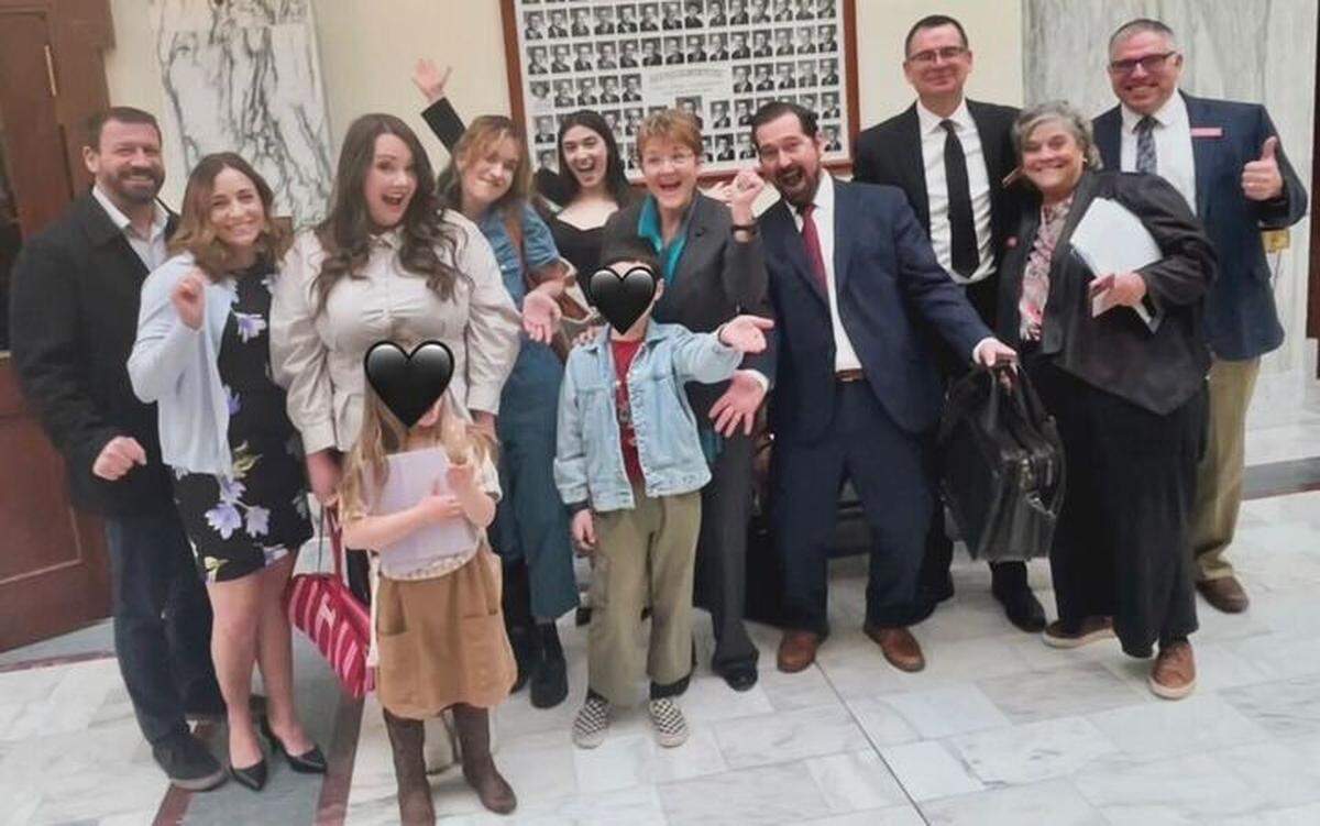 Some of the foster parents who advocated for the laws appear at the Capitol for the signing after sharing their stories in legislative testimony.