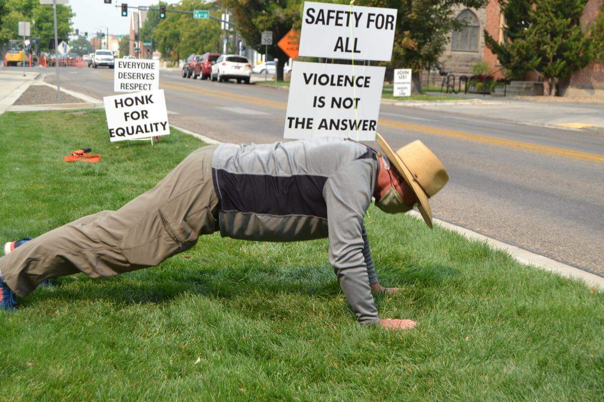 Tom Neale does pushups Monday as part of the State Street Demonstration for American Values on State Street behind the Idaho State Capitol. Demonstrators bring a decidedly positive and fun vibe to their cause.