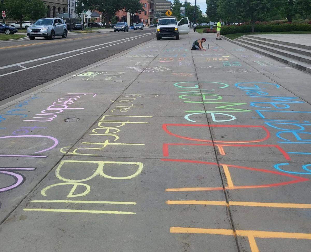 Idaho Abortion Rights members wrote in chalk outside the Idaho Capitol in Boise on Tuesday prior to demonstrations there.