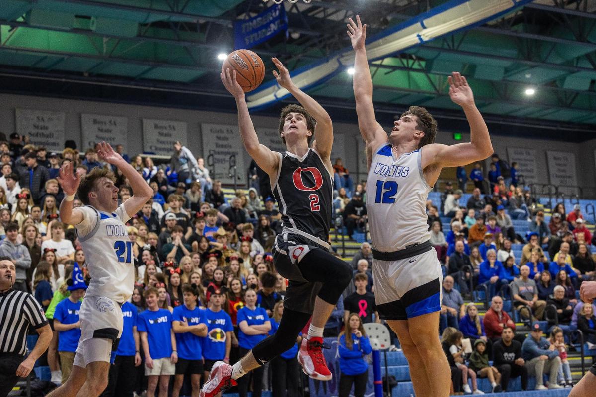 Owyhee junior Jackson Rogers slices his way to the basket Saturday at Timberline.