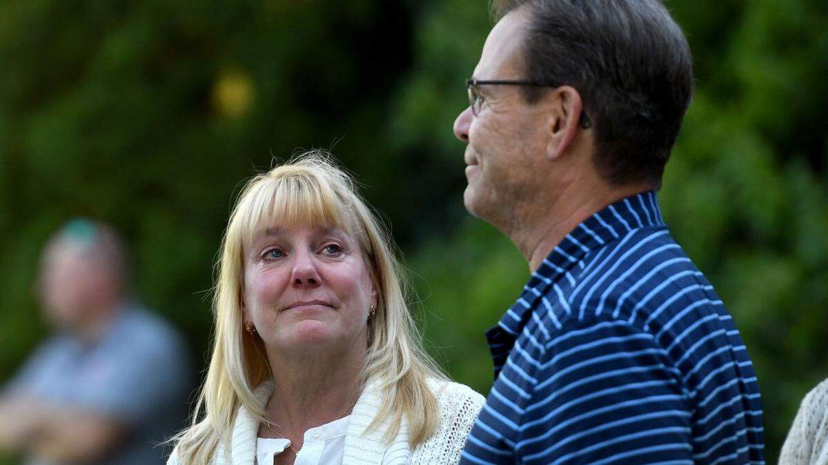 Senior executive assistant Shannon Goodrich looks toward then-North Idaho College president Rick MacLennan as he is greeted by a crowd in front of the Sherman Building to bid a “final farewell” to him in Coeur d’Alene on Thursday, Sept. 23. He was fired by the college Board of Trustees.