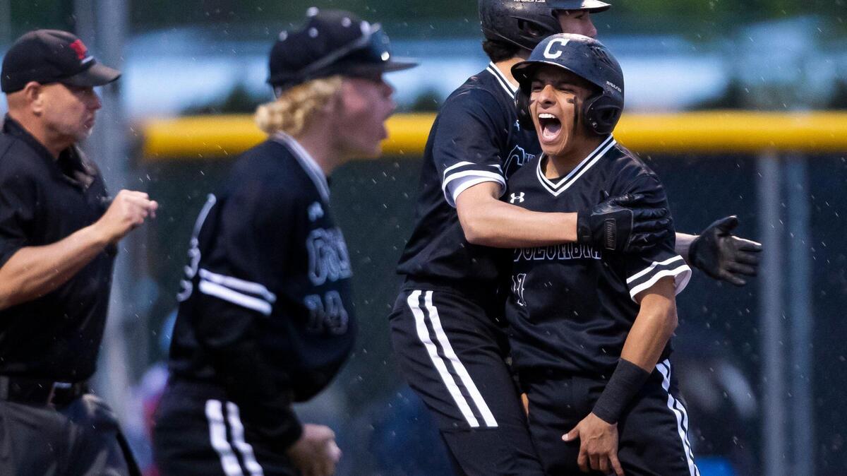 Columbia junior Isaiah Capetillo celebrates with teammates after scoring the tying run in the top of the seventh inning, forcing extra innings against Middleton. The Wildcats rallied in the eighth inning and held off the Vikings to win the 4A District Three baseball championship 5-1 Thursday at Bishop Kelly High School.