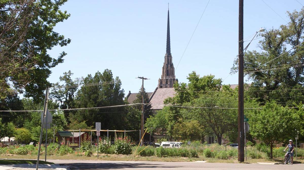 The Cathedral of the Rockies is in the background in this view looking south from Fort Street toward Lot 75, a city block. Homes there were torn down or moved elsewhere more than a decade ago to make way for a church-planned apartment and parking complex that was never built. Now the church is considering building affordable housing there. The garden in the foreground is used by Boise High School students and local residents. A church parking area is behind the garden.