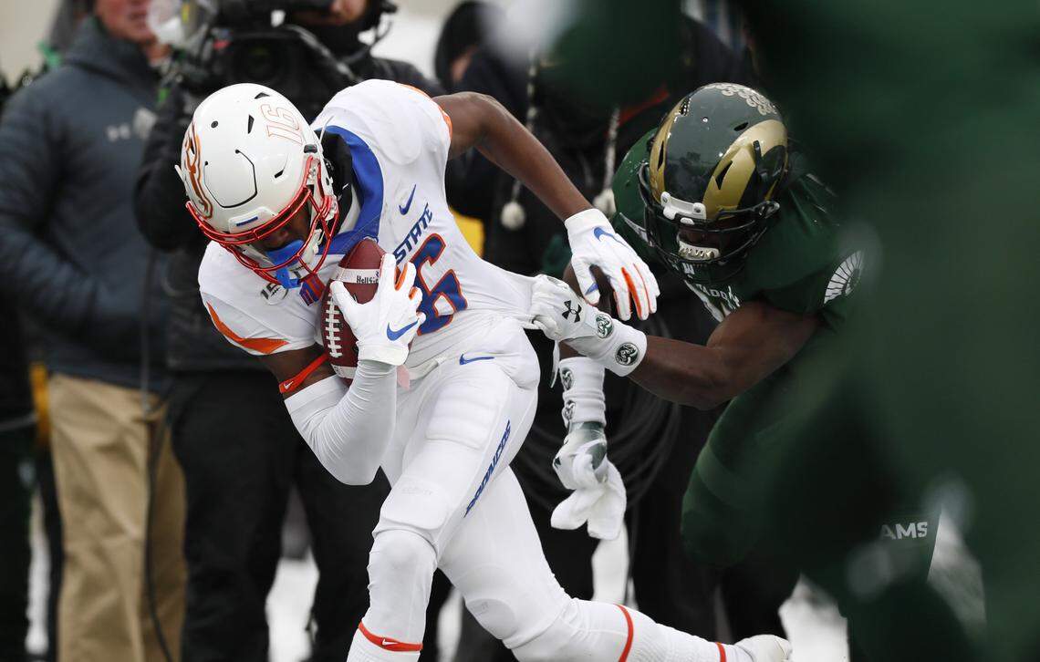 Boise State wide receiver John Hightower is pulled down by Colorado State safety Logan Stewart after catching a pass for a short gain in the first half of the Broncos’ regular season finale last weekend in Fort Collins, Colorado.